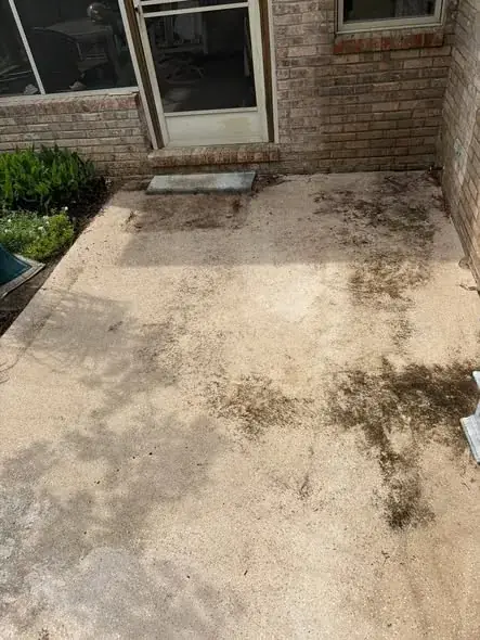 Stained concrete patio before cleaning